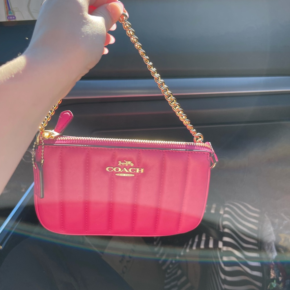 Gently used pink Coach shoulder bag.